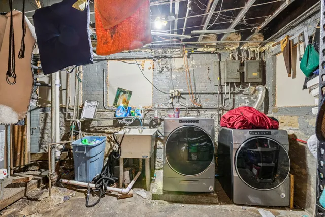 a utility room with sink dryer and washer