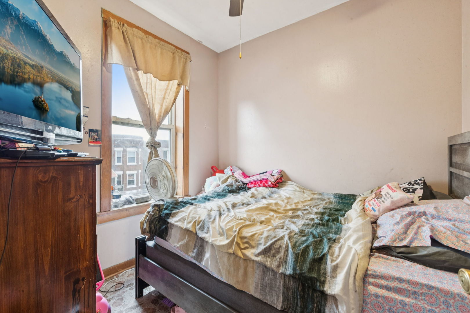 1012 North Ridgeway Avenue Chicago, IL 60651 - Photo 7 of 31 a bedroom with a bed and large windows