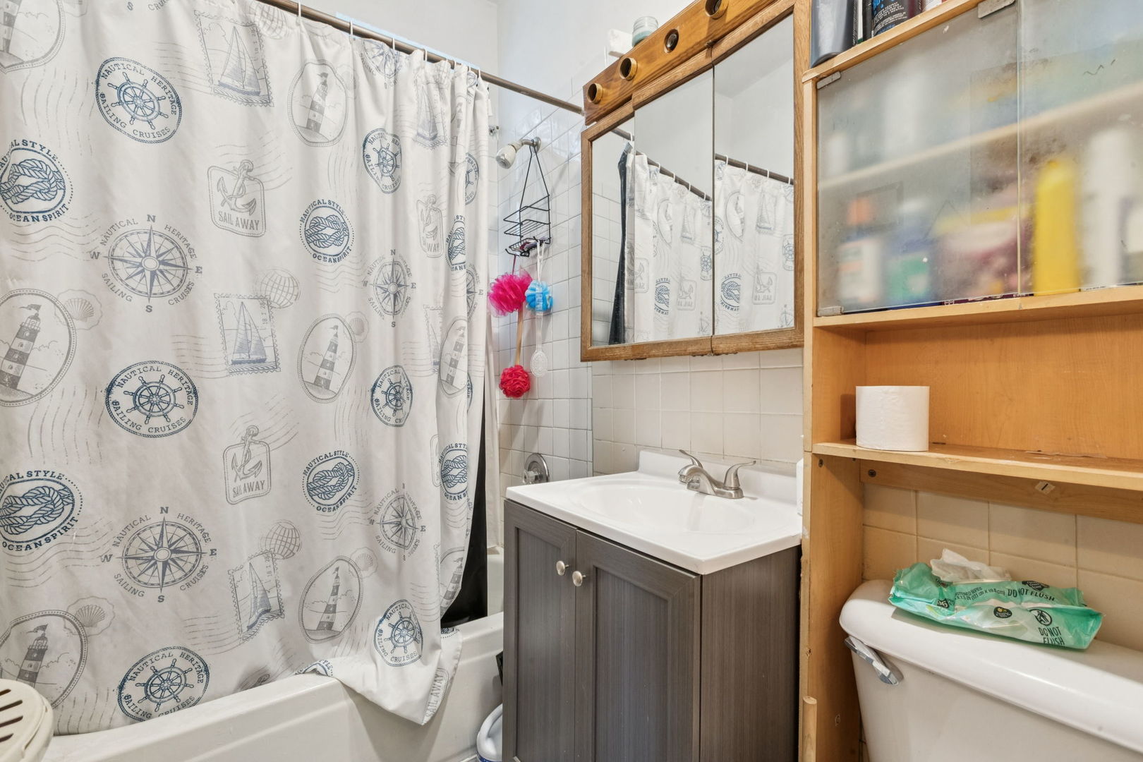 1012 North Ridgeway Avenue Chicago, IL 60651 - Photo 8 of 31 a bathroom with a sink and a shower curtain