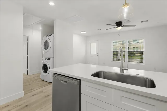 a bathroom with a granite countertop sink a large mirror and shower