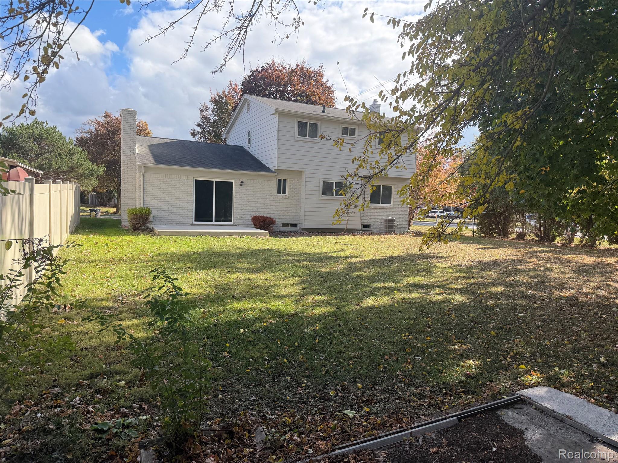 20698 Coachwood Road Riverview, MI 48193 - Photo 36 of 37 Rear view of house with a patio, brick siding, and a chimney
