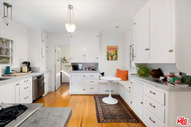 a large white kitchen with cabinets
