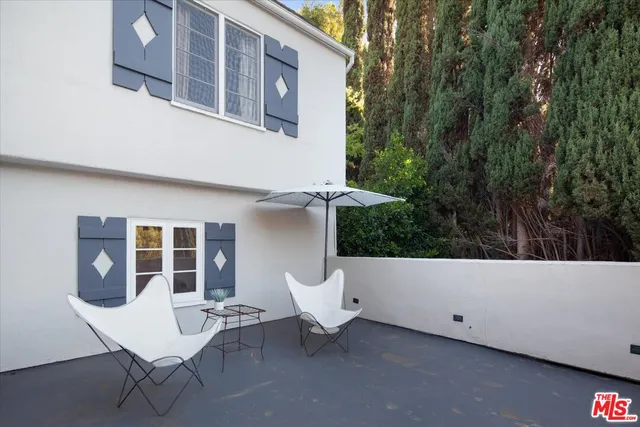 a backyard view with a seating space