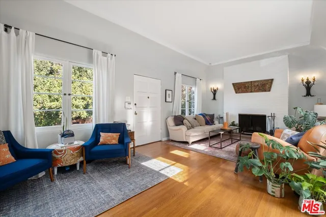 a living room with furniture fireplace and a table
