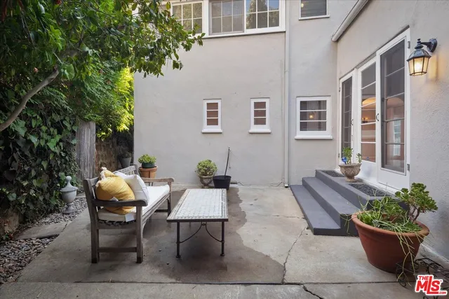 a view of a chairs and table in the back yard of the house