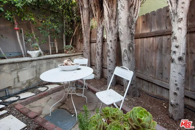 a outdoor space with a table and chairs
