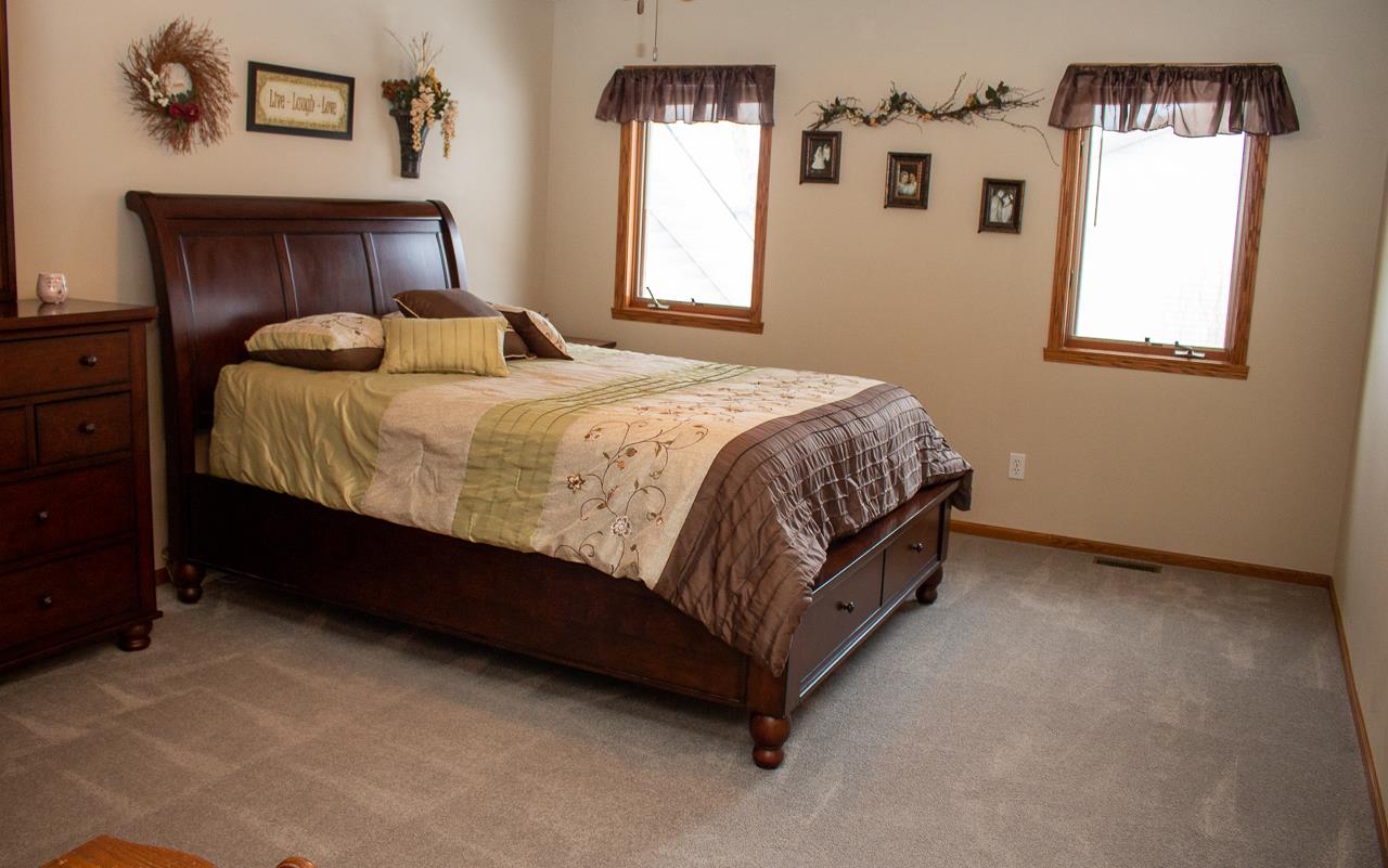 7073 Rye Ridge Trail Cherry Valley, IL 61016 - Photo 11 of 24 a spacious bedroom with a bed and window