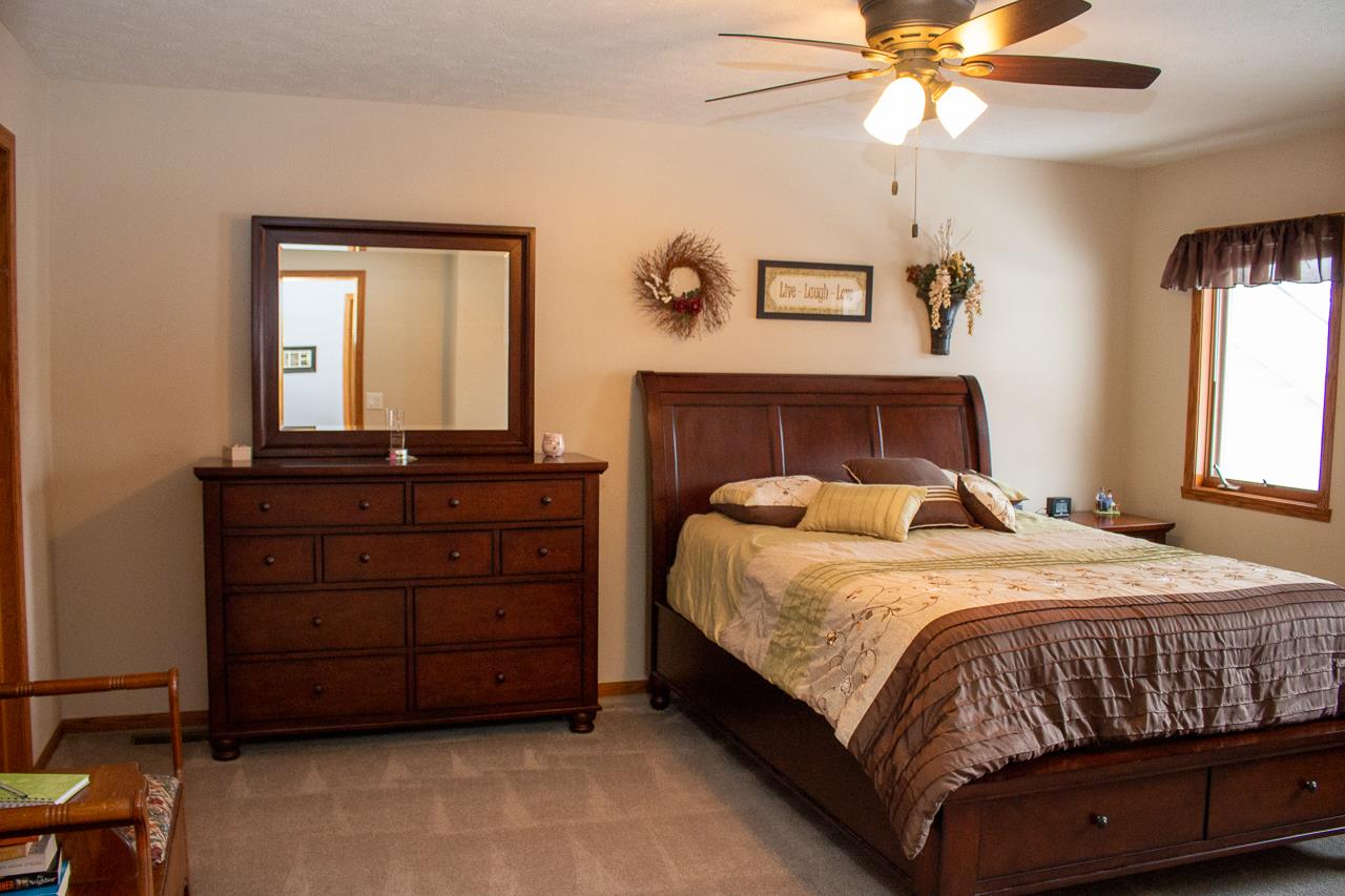 7073 Rye Ridge Trail Cherry Valley, IL 61016 - Photo 10 of 24 a bedroom with a bed and a dresser