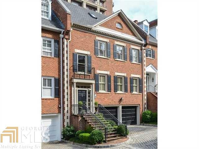 a front view of a building with a yard