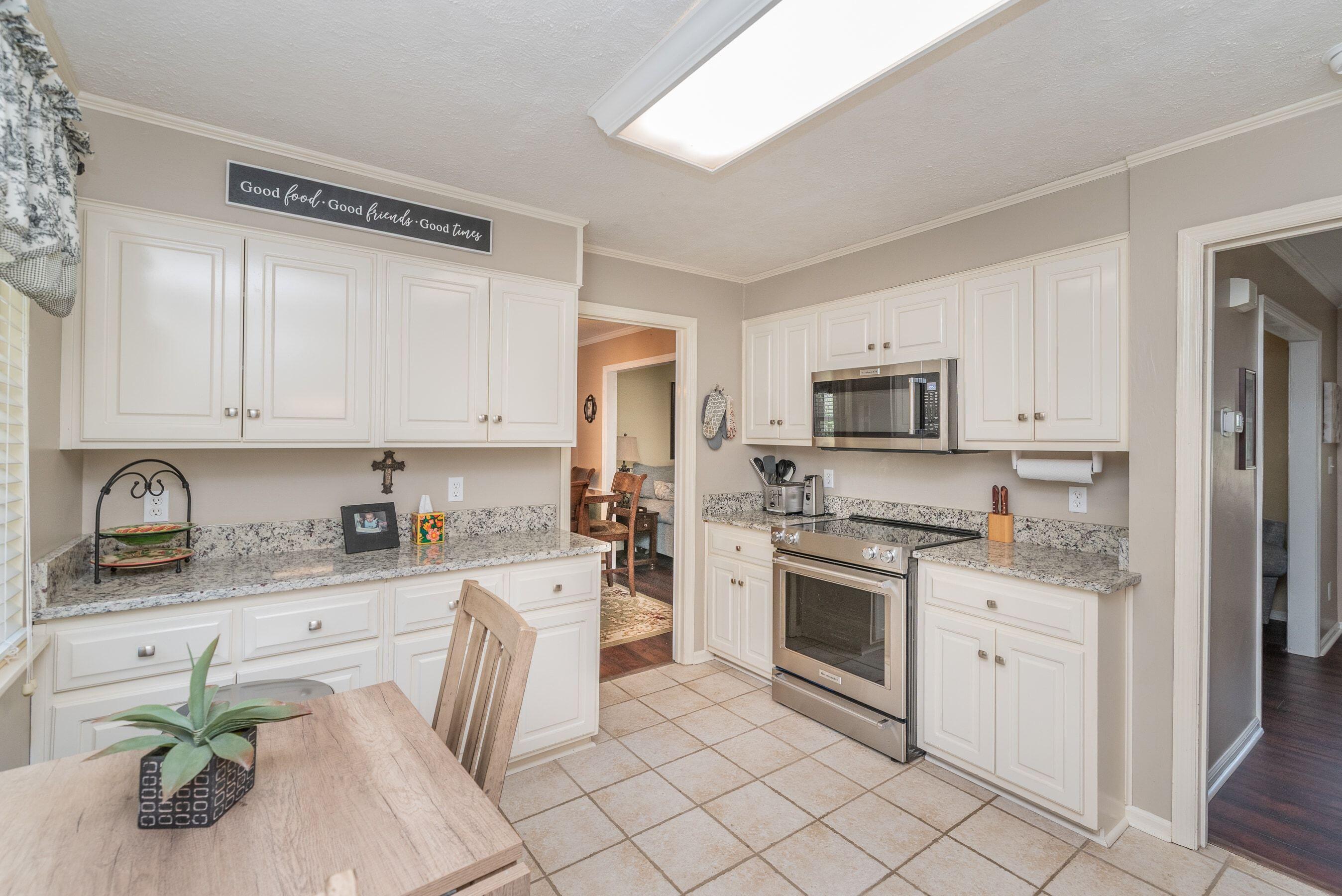 1117 Ridgemont Drive Aiken, SC 29803 - Photo 12 of 49 a kitchen with granite countertop white cabinets and stainless steel appliances