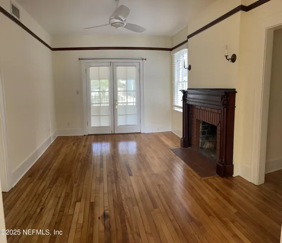 wooden floor in an empty room with a fireplace