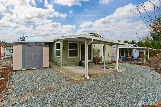 a swimming pool with outdoor seating and yard