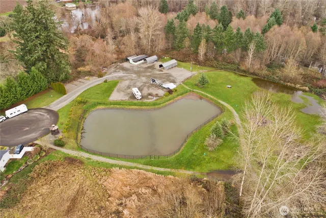 an aerial view of a house with yard and lake view