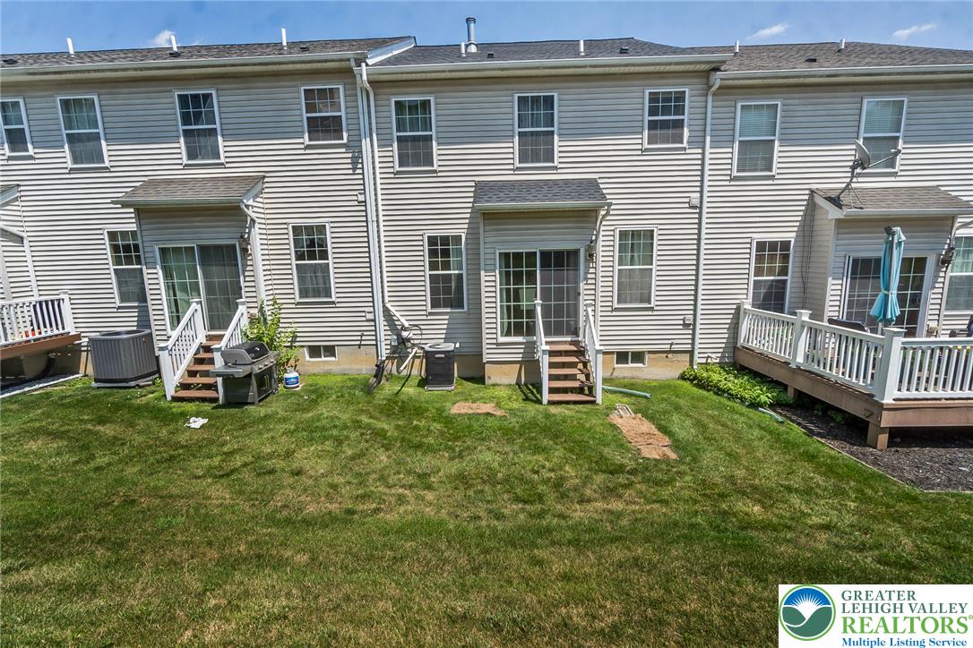 3566 Penfield Way Nazareth, PA 18064 - Photo 46 of 47 A well-maintained lawn stretches behind these inviting townhomes with individual outdoor living spaces.