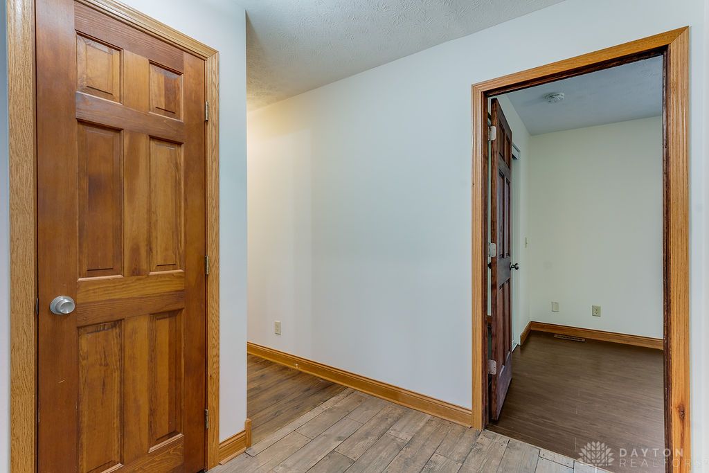 7400 Cook-Jones Road Waynesville, OH 45068 - Photo 26 of 72 This entry showcases durable flooring and classic wooden doors, defining a welcoming transition space.
