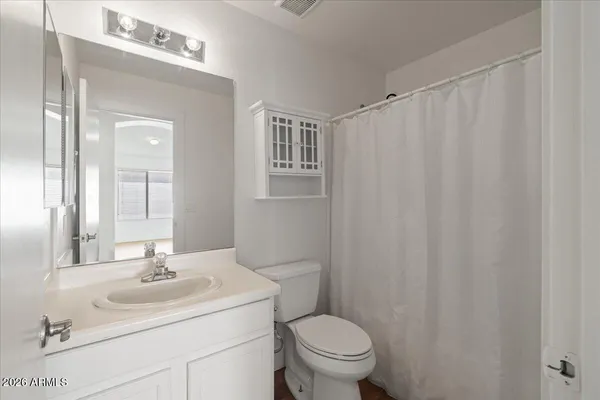 a bathroom with a sink toilet and mirror