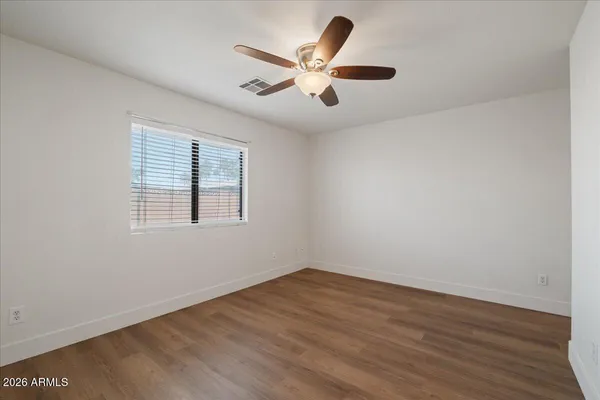 wooden floor in an empty room with a window
