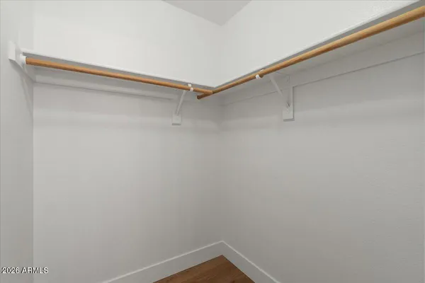 a small space with a wooden floor and a window