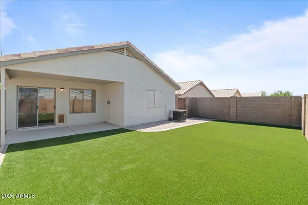 a view of a backyard with table and chairs and wooden fence