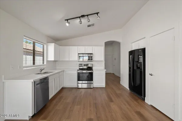 a kitchen with stainless steel appliances granite countertop a stove and refrigerator