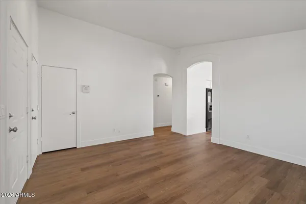a view of an empty room with wooden floor
