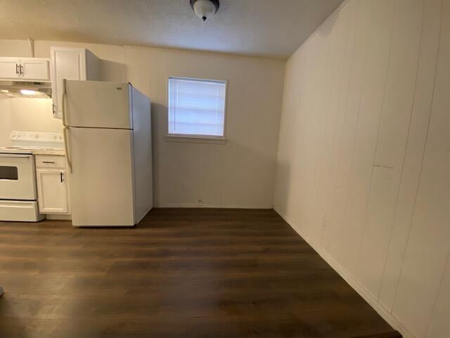 1310 54th Street, Unit 7 Lubbock, TX 79412 - Photo 1 of 7 a view of a refrigerator in kitchen and an empty room