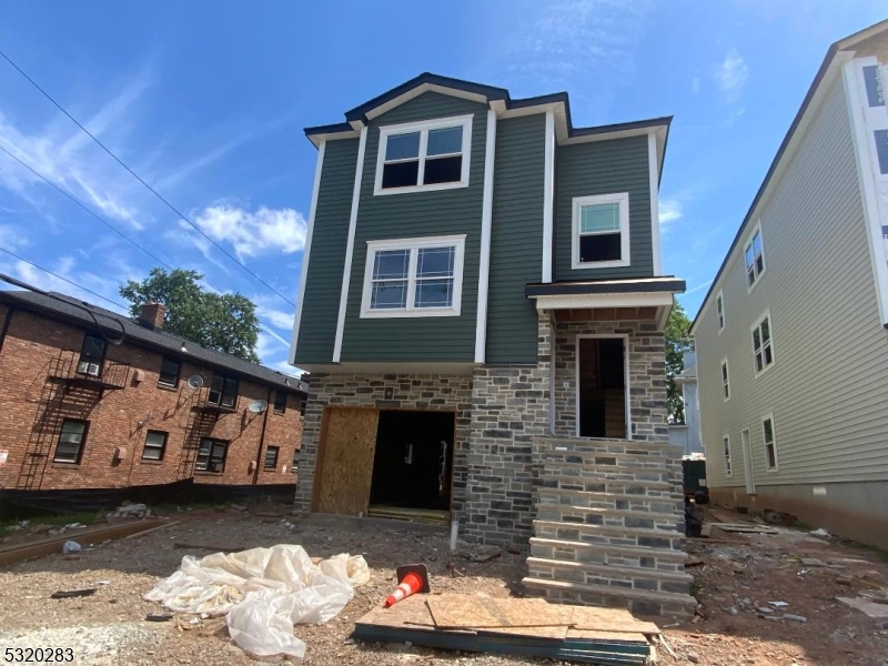 307 Chilton Street Elizabeth, NJ 07208 - Photo 3 of 10 a front view of a house with a yard