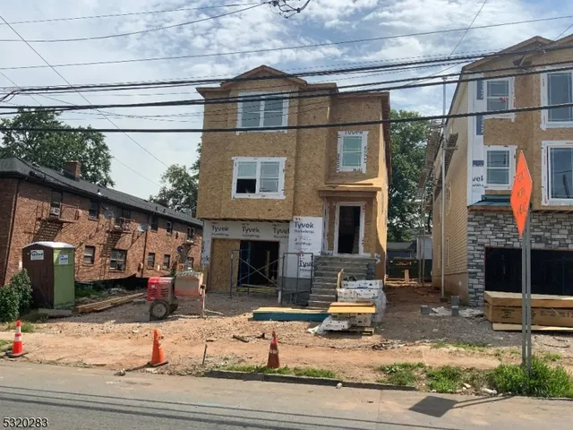 a front view of a house with garage and glass door