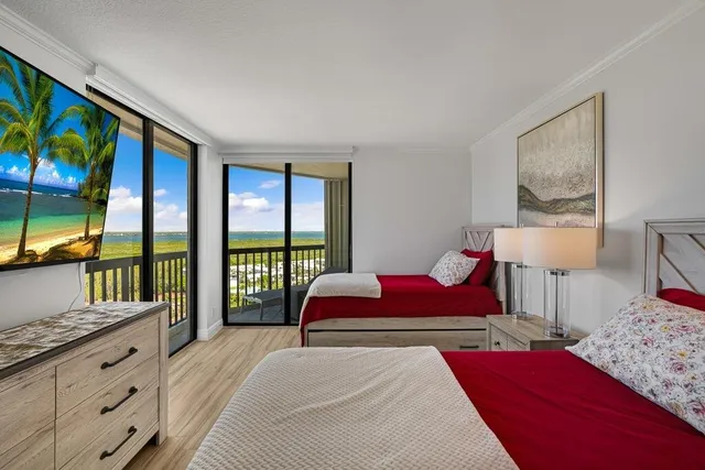 a bedroom with a large bed and a large window