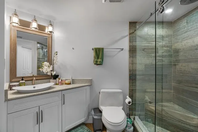 a bathroom with a toilet sink and shower