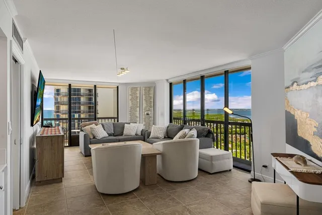 a living room with furniture and a floor to ceiling window