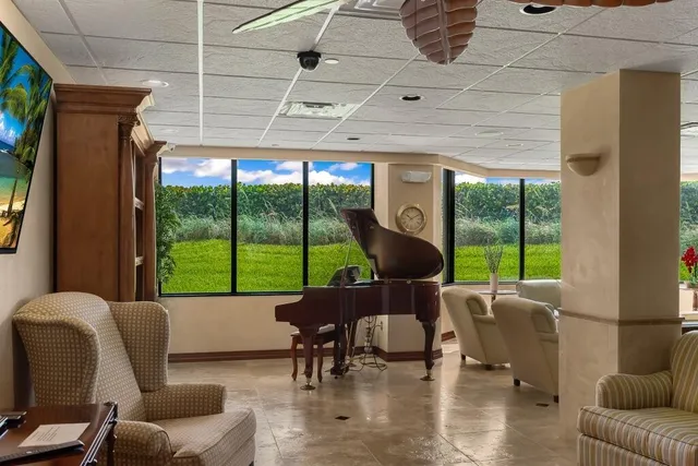 a living room with furniture and a floor to ceiling window