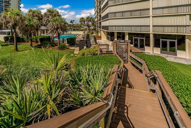 a view of a house with backyard and sitting area