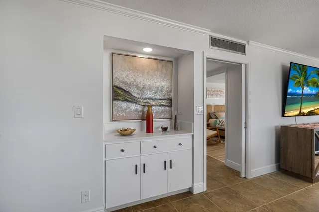 a view of cabinets with wooden floor and windows