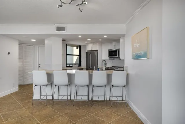 a view of kitchen with dining area and windows