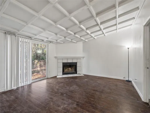 a view of a livingroom with an empty space and a fireplace