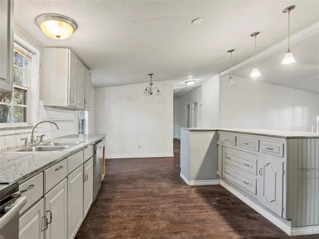 a view of kitchen with stainless steel appliances cabinets and wooden floor