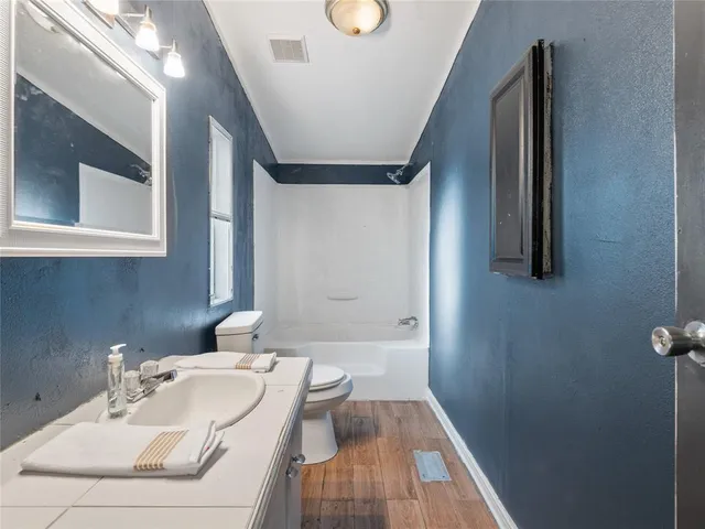a view of a kitchen with wooden floor and a window