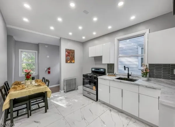 a kitchen that has a sink and a stove in it