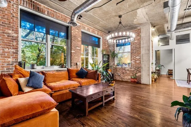 a living room with furniture and a chandelier