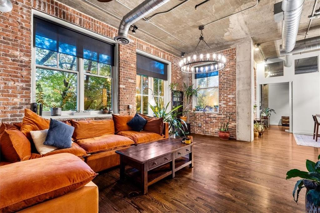 a living room with furniture and a chandelier