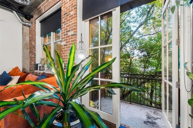 a view of a house with a large windows and flower plants