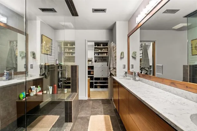 a large living room with stainless steel appliances kitchen island granite countertop a large window