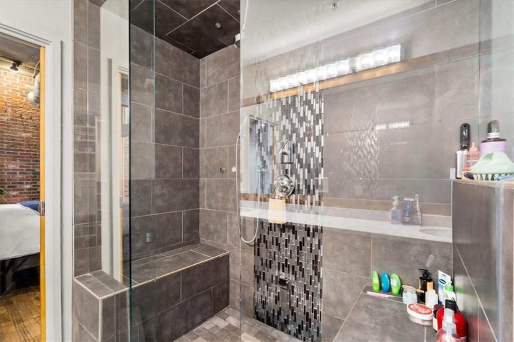 3235 Roswell Road Northeast, Unit 609 Atlanta, GA 30305 - Photo 18 of 30 a bathroom with a shower and a sink