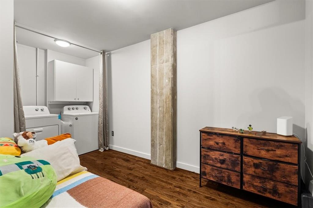 3235 Roswell Road Northeast, Unit 609 Atlanta, GA 30305 - Photo 24 of 30 a bedroom with a bed and a dresser