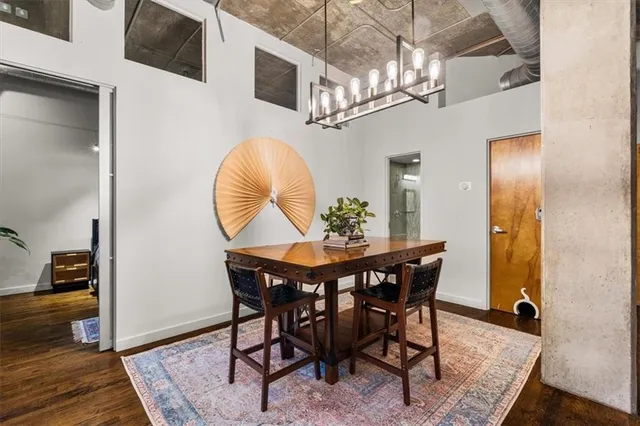 a dining room with furniture a chandelier and wooden floor