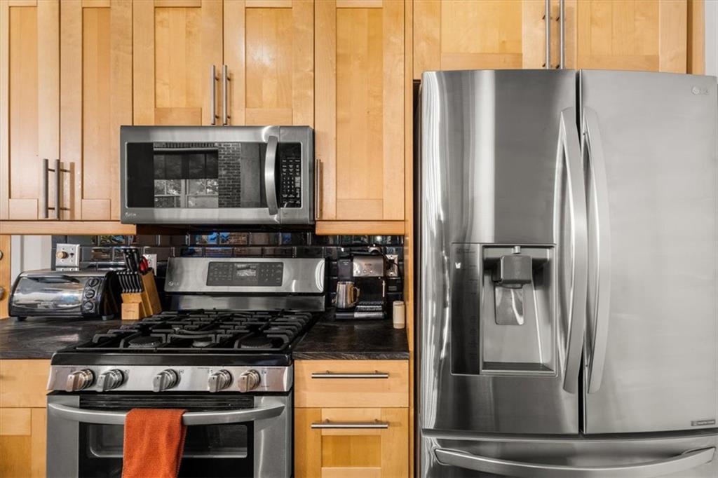 3235 Roswell Road Northeast, Unit 609 Atlanta, GA 30305 - Photo 10 of 30 a kitchen with stainless steel appliances granite countertop a refrigerator and a stove