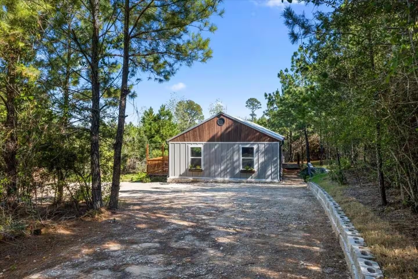 201 Winfield Thicket Road Bastrop, TX 78602 - Photo 3 of 36 a front view of a house with a yard and large trees