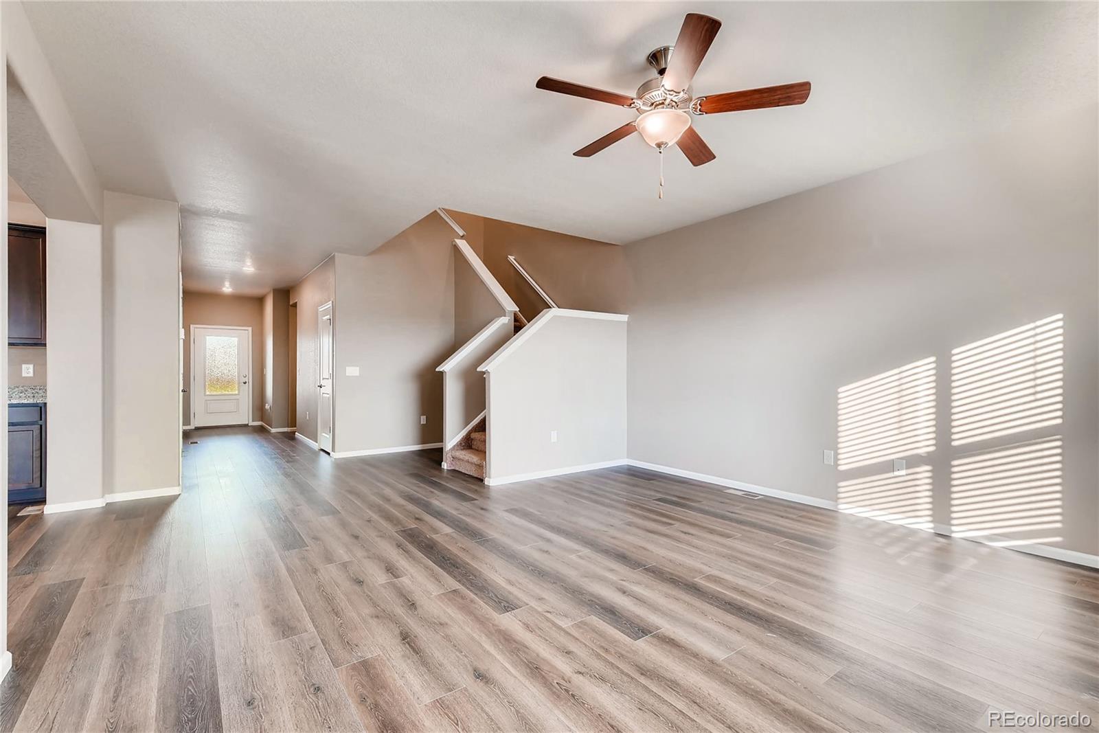 7132 Shavano Circle Frederick, CO 80504 - Photo 2 of 14 a view of empty room with wooden floor and fan