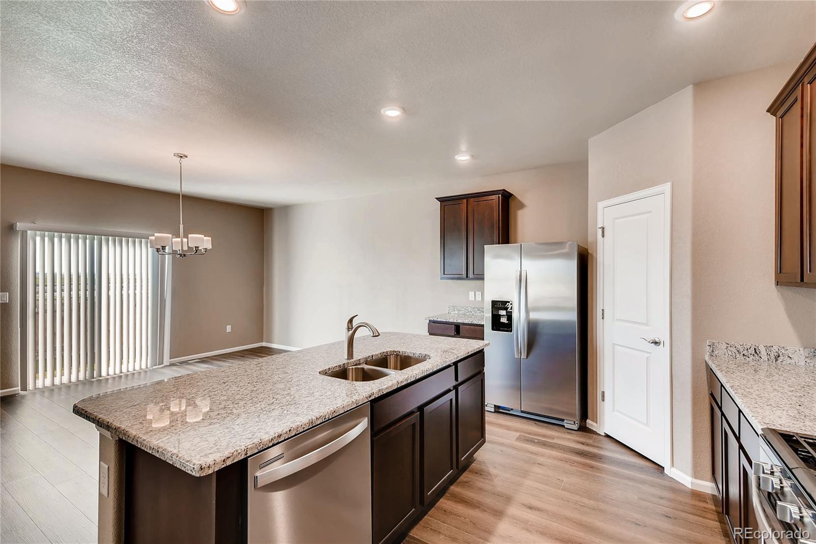 7132 Shavano Circle Frederick, CO 80504 - Photo 5 of 14 a kitchen with stainless steel appliances granite countertop a sink stove and refrigerator